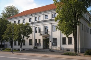 Light façade of Telšiai Žemaitė Drama Theatre with its central balcony and Respublikos Street entrance