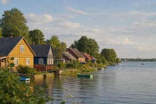 Traditional colorful Karaim wooden houses along Lake Galvė in Trakai with small boats