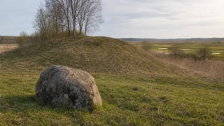 Green hill of Varnupiai Hillfort and the mythological Padkavinis stone in the Žuvintas Biosphere Reserve landscape