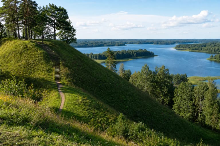 Velikuškių piliakalnis stačiais šlaitais virš Sartų ežero Zarasų rajone