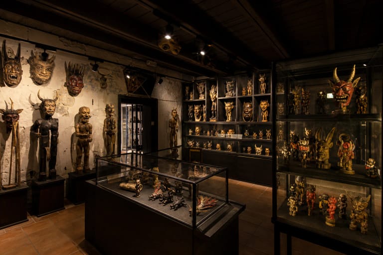 Devils' Museum in Kaunas exhibition with wooden devil carvings and dark display halls