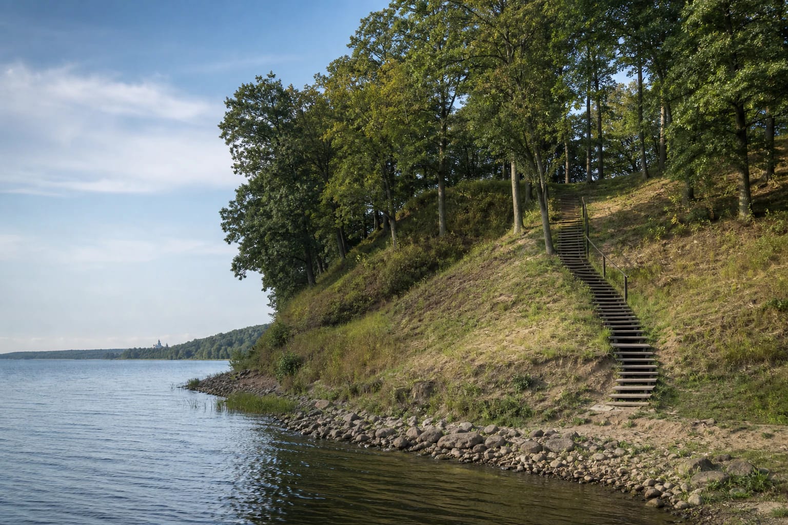 Grassy slope and timber steps of Vieškūnai Hillfort beside the Kaunas Reservoir