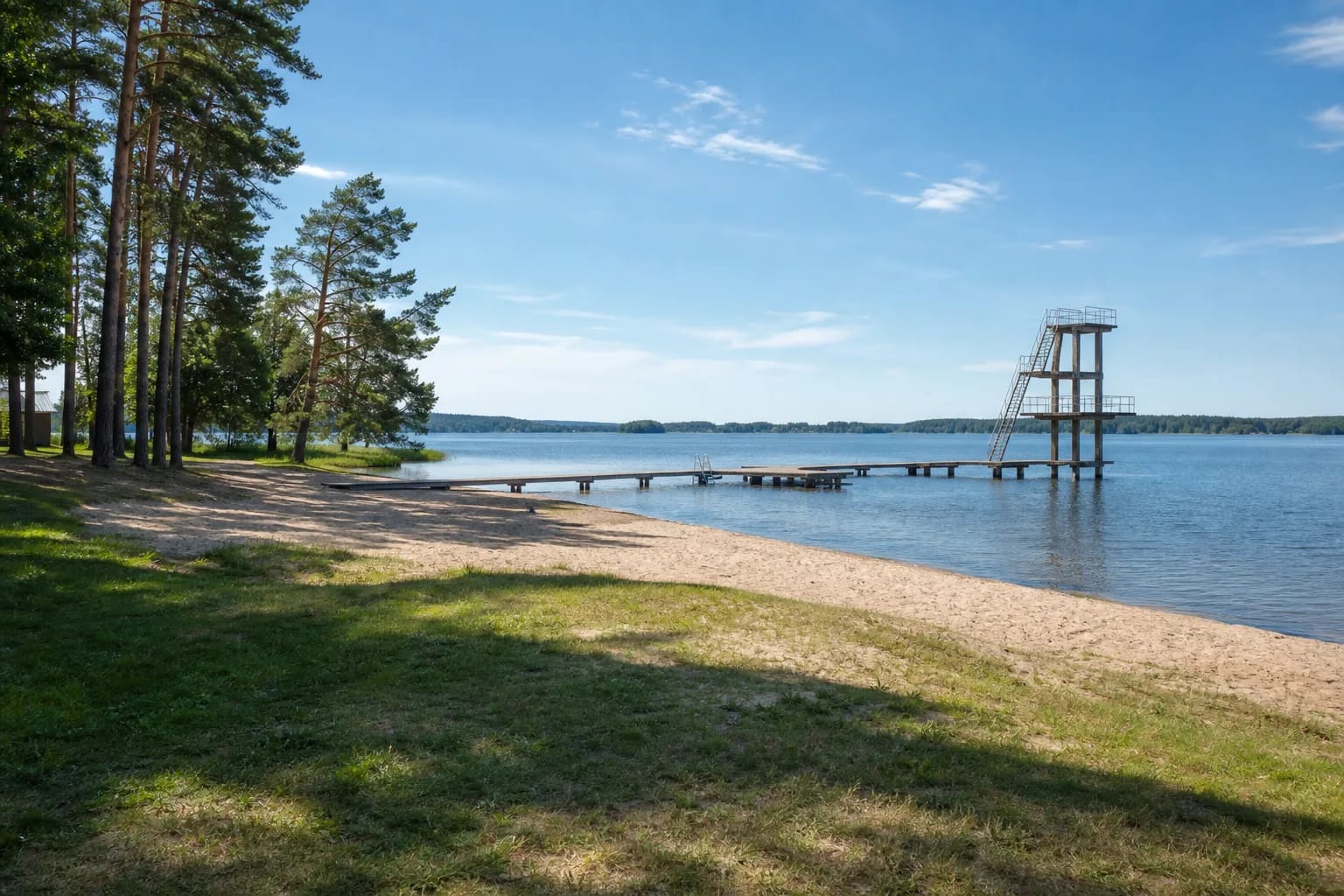 Sandy Zarasaitis Lake beach with a timber pier and tall diving tower over the water