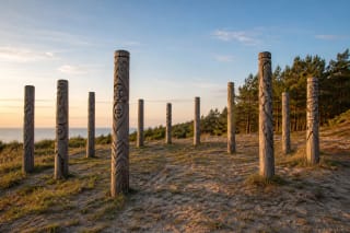 Oak posts of Žemaičių Alkas in Šventoji on a coastal dune beside pine trees