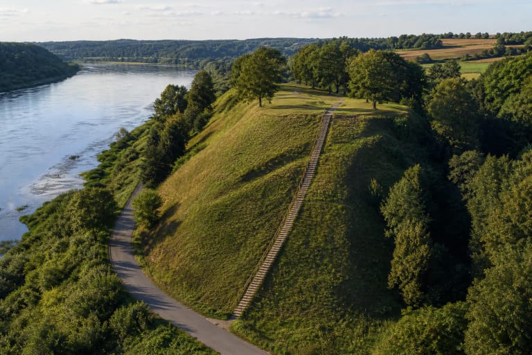 Green slope and timber stairs of Žemoji Panemunė Hillfort I above the Nemunas valley