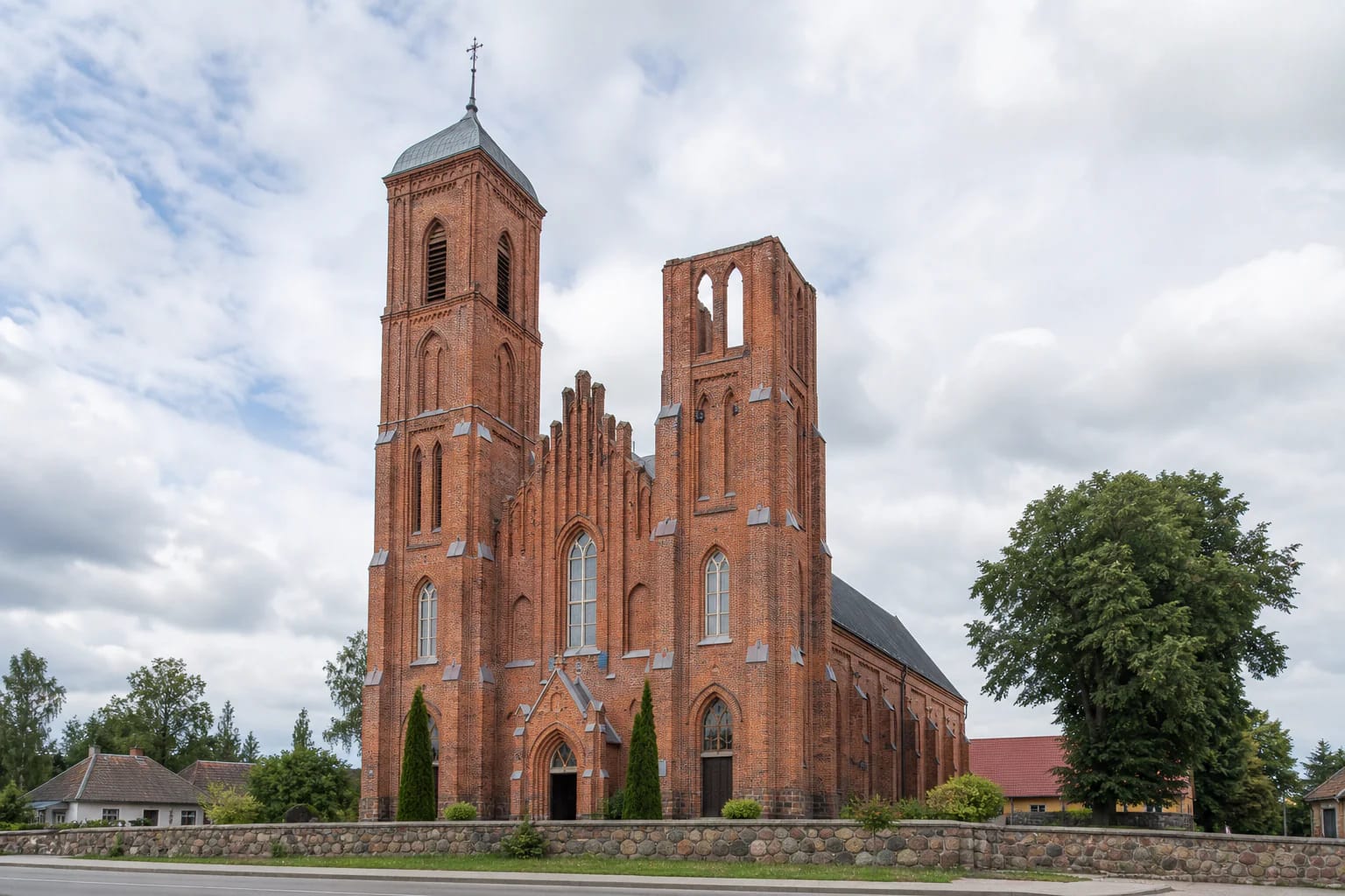Red-brick Žiežmariai St. James Church with one completed tower and one unfinished tower